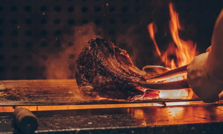 person barbecuing meat