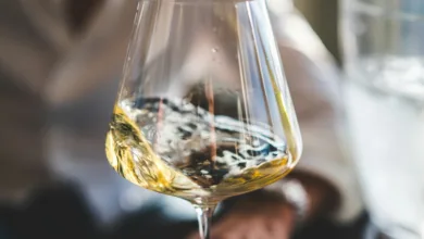 clear wine glass with yellow liquid